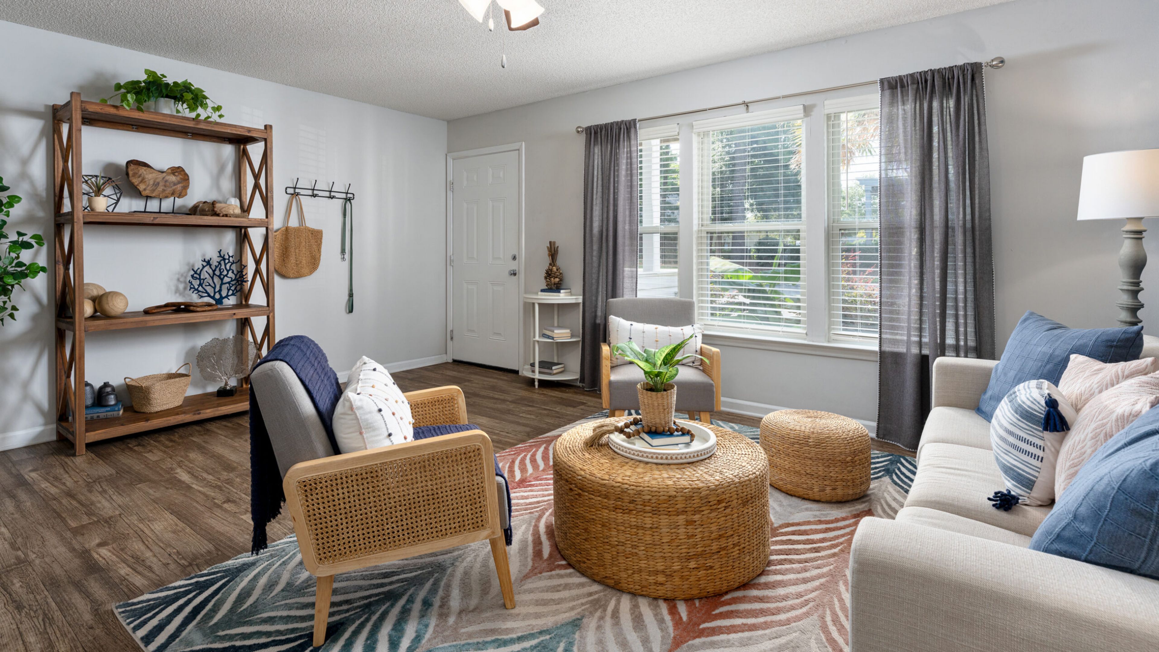 Hawthorne at New Centre apartment living room with coastal decorated sofa, chairs and coffee table